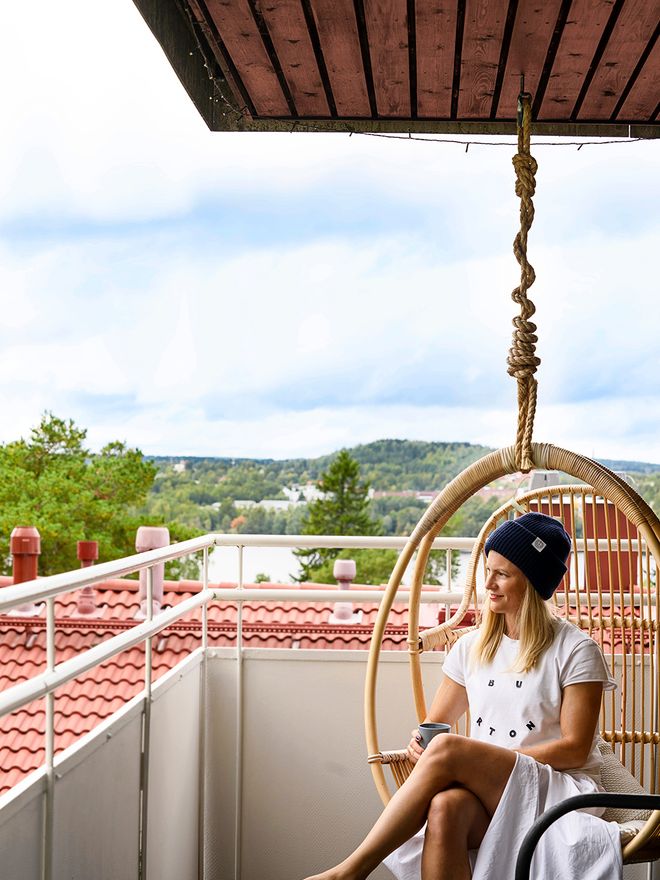 Photographer Outi Aalto sitting in a hanging chair