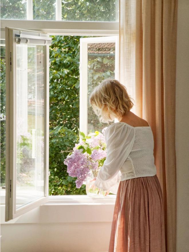 Iina Hautala by the window in her home