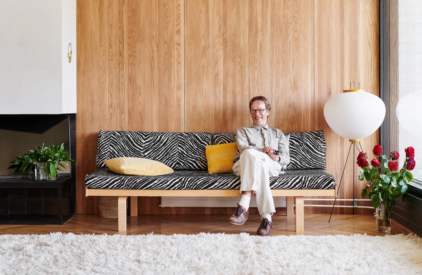Pekka Jylhä sitting in his living room