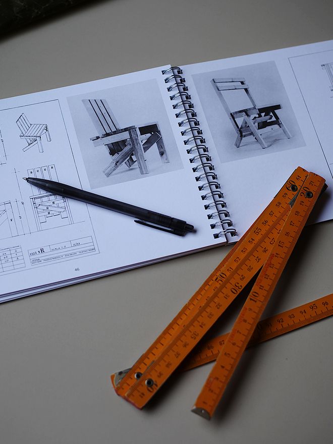An open book and a measure on a table.