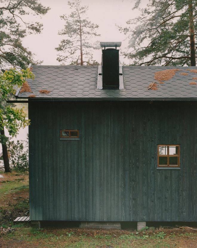 The black sauna cabin wall with two windows