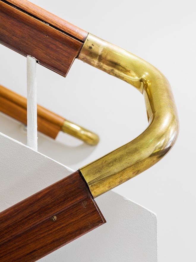 A brass detail in a staircase railing