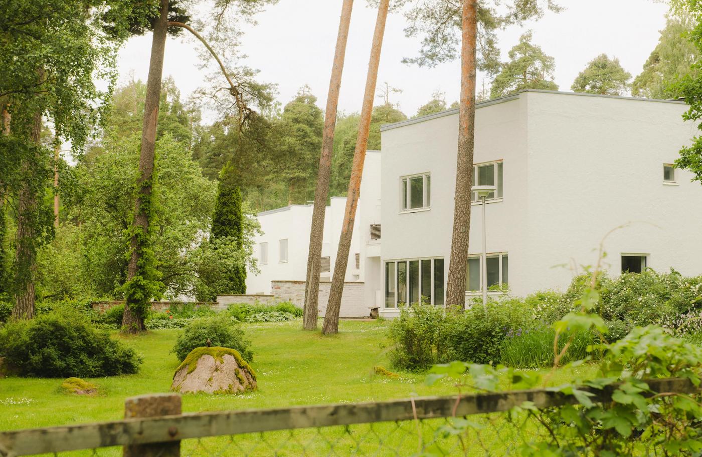 Exterior view of the Rantala row house in Sunila, with its lush green yards