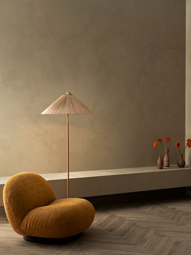 An image featuring GUBI's Paavo Tynell's 9602 floor lamp as part of the living room interior.