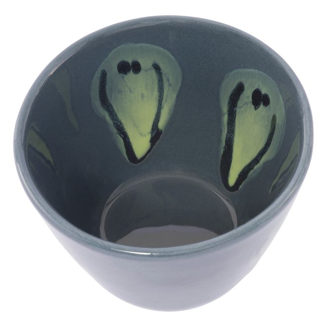 Close-up of a colorful Frizbee Ceramics cup, its 90s-inspired smiley face motif bringing a playful pop of color to the table