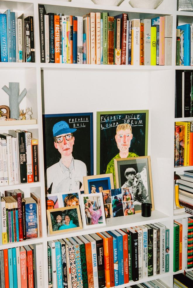 A photo of a bookshelf filled not only with books but also with beautiful art objects