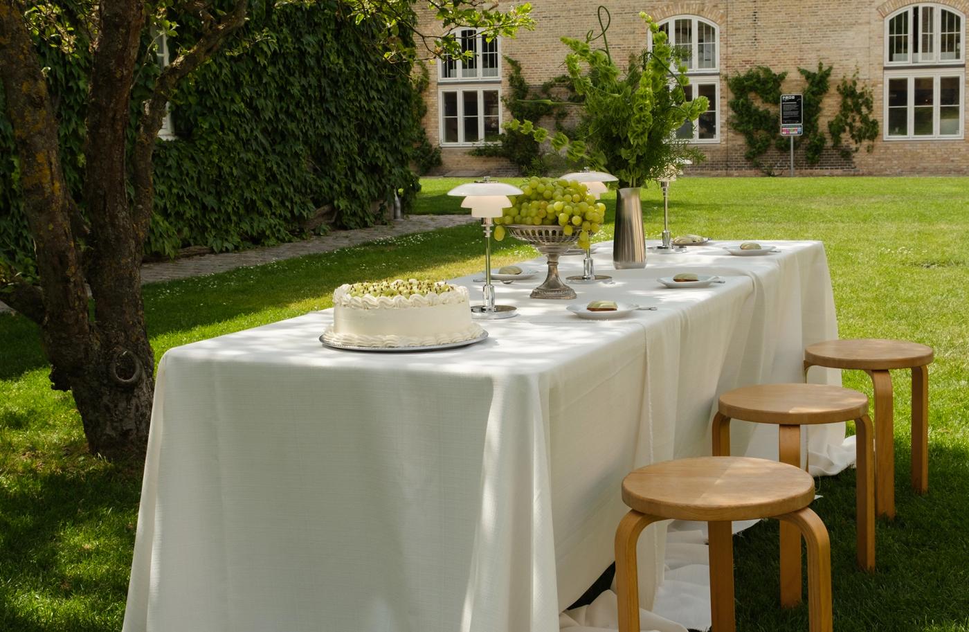 Outdoor table setting with Louis Poulsen lamps