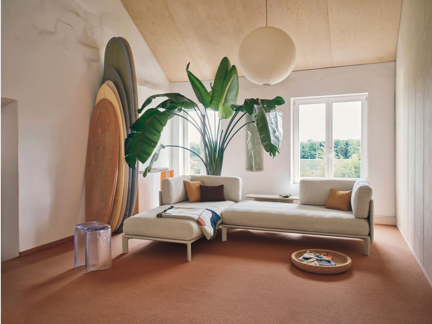 Vitra's Anagram sofa in a room with surfboards and a big plant