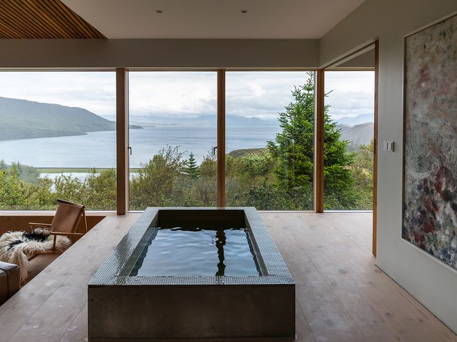 An image of the Holiday home by Þingvallavatn by KRADS architects: a leisure home located in Iceland in the middle of a picturesque scenery. This image features the buildings interior: a pool in the lounge area.