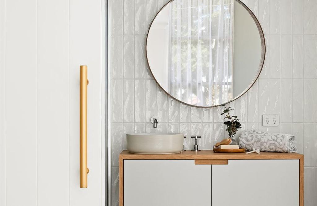 Project Drummond (Drummond street bathroom's powder area with single sink and round mirror)