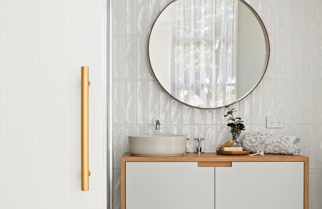 Project Drummond (Drummond street bathroom's powder area with single sink and round mirror)