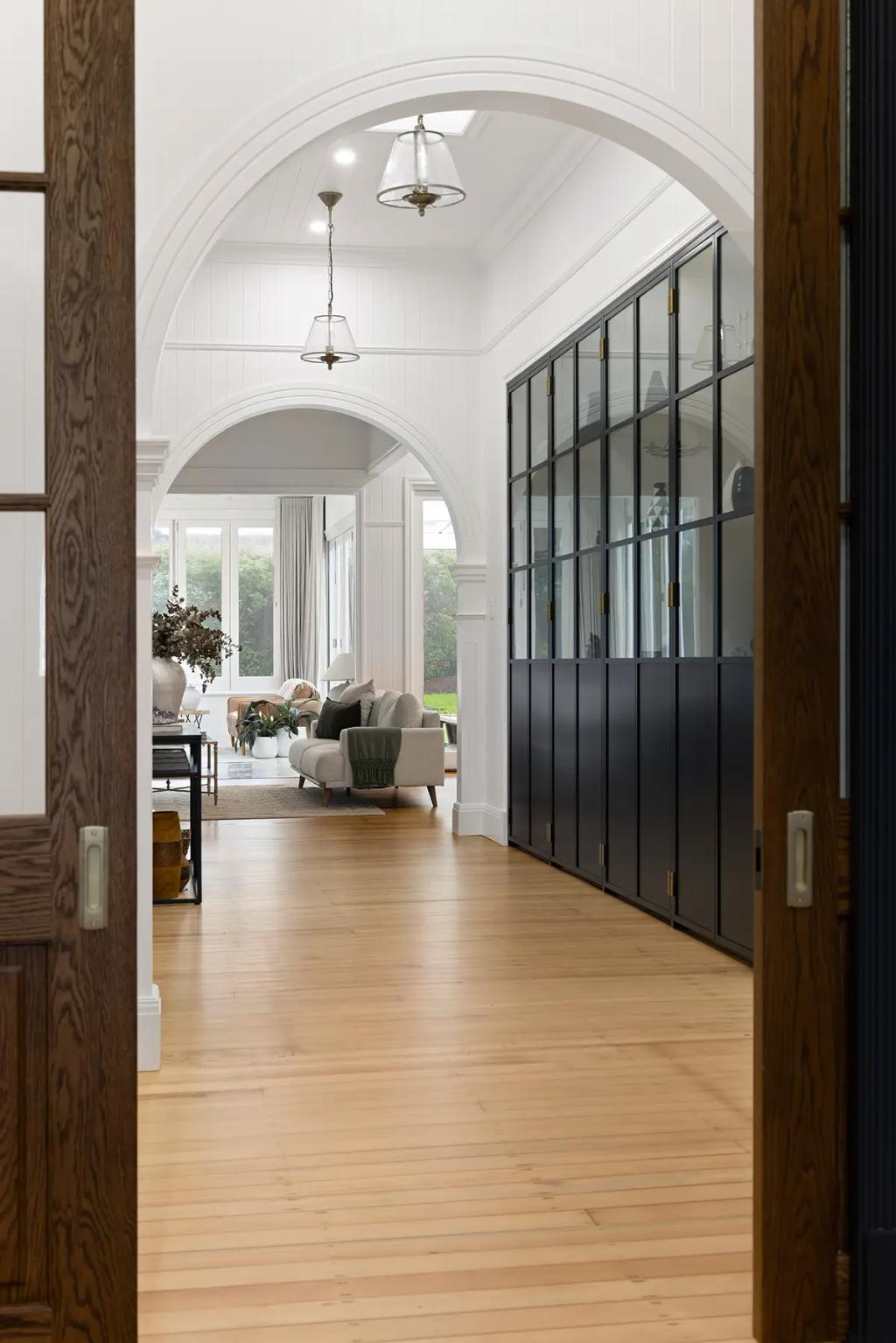 Project Franklin (Interior view of home with wooden floors and arched doorways.)