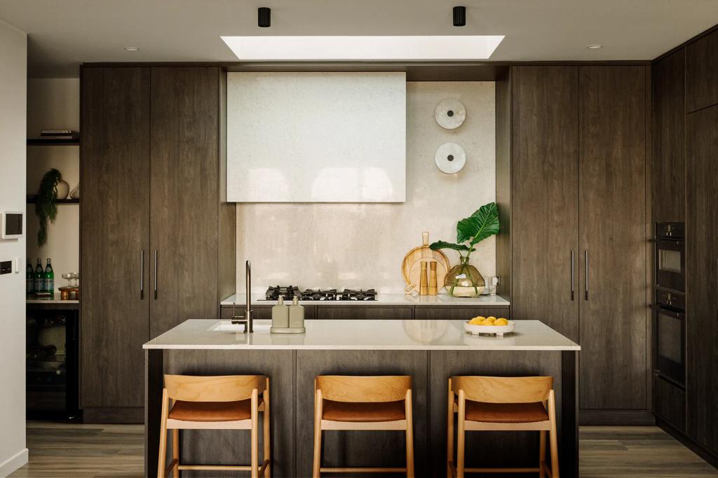 Lavish Morada (Modern kitchen with wood cabinetry, island seating, and minimalist decorative accents.)