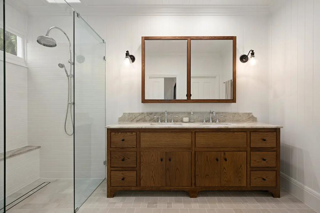 Project Franklin (Walk-in shower beside double vanity with wood cabinetry.)
