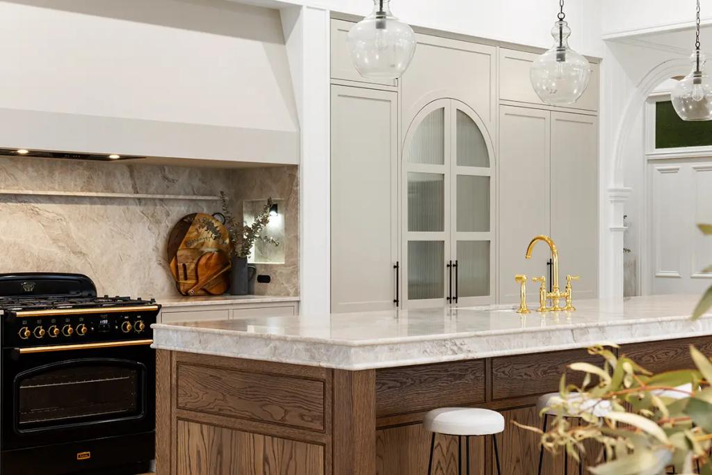 Project Franklin (Gold tap and marble island facing arched pantry doors.)