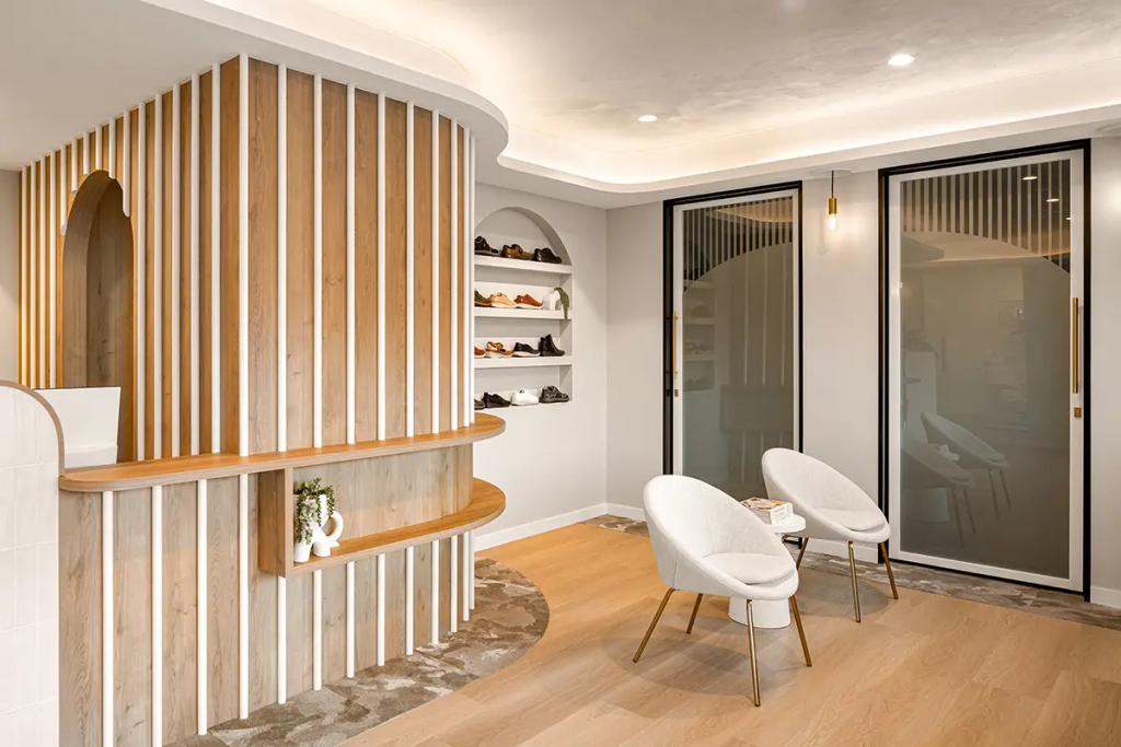 Lavish Constructions - Sole Podiatry (Modern podiatry waiting area with chairs and shelving.)