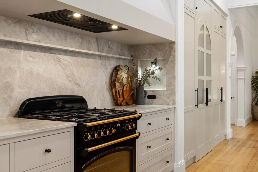 Project Franklin (Black oven with gold trim set in marble and white tones)