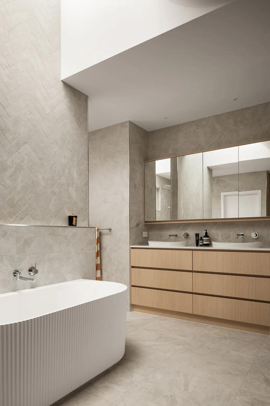 Cheltenham (Freestanding tub beside wood vanity and wall mirror)