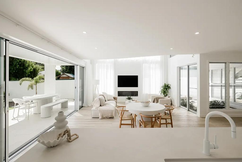 Project Vuse (A modern, minimalist living room with white walls, furniture, and sheer curtains)