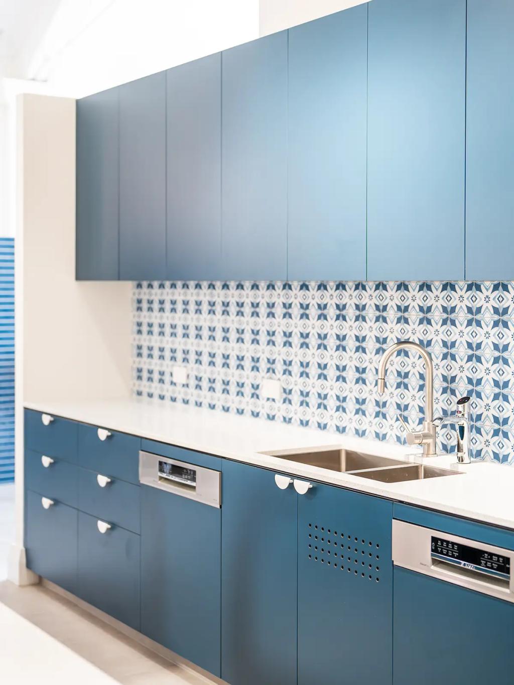 Downlands College Toowoomba Refurbishment (Sleek kitchen with blue cabinets, white countertop, double sink, and patterned blue-and-white backsplash.)