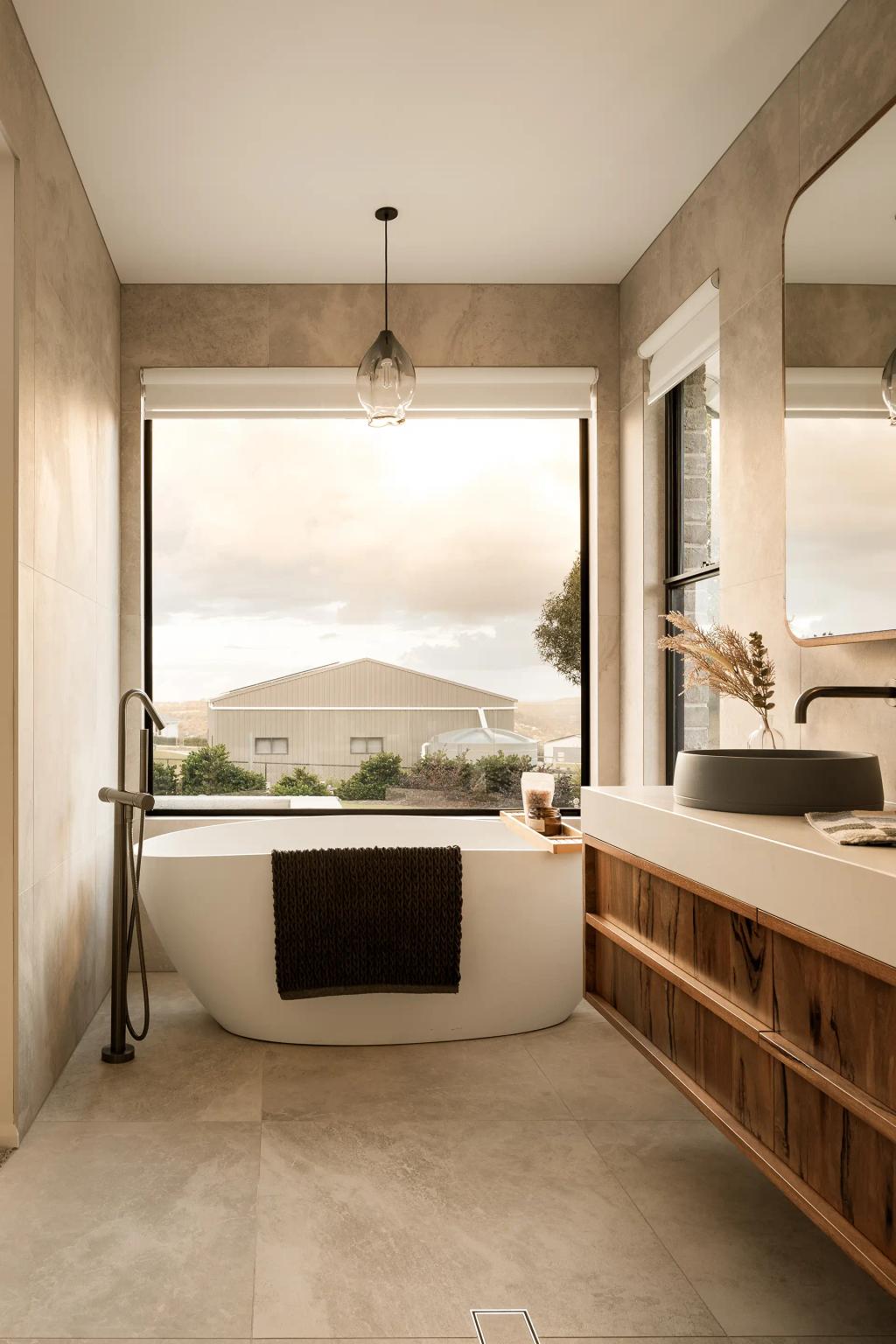 Project Mount Rascal (Modern bathroom with a freestanding tub, large window, wooden vanity, and pendant light)
