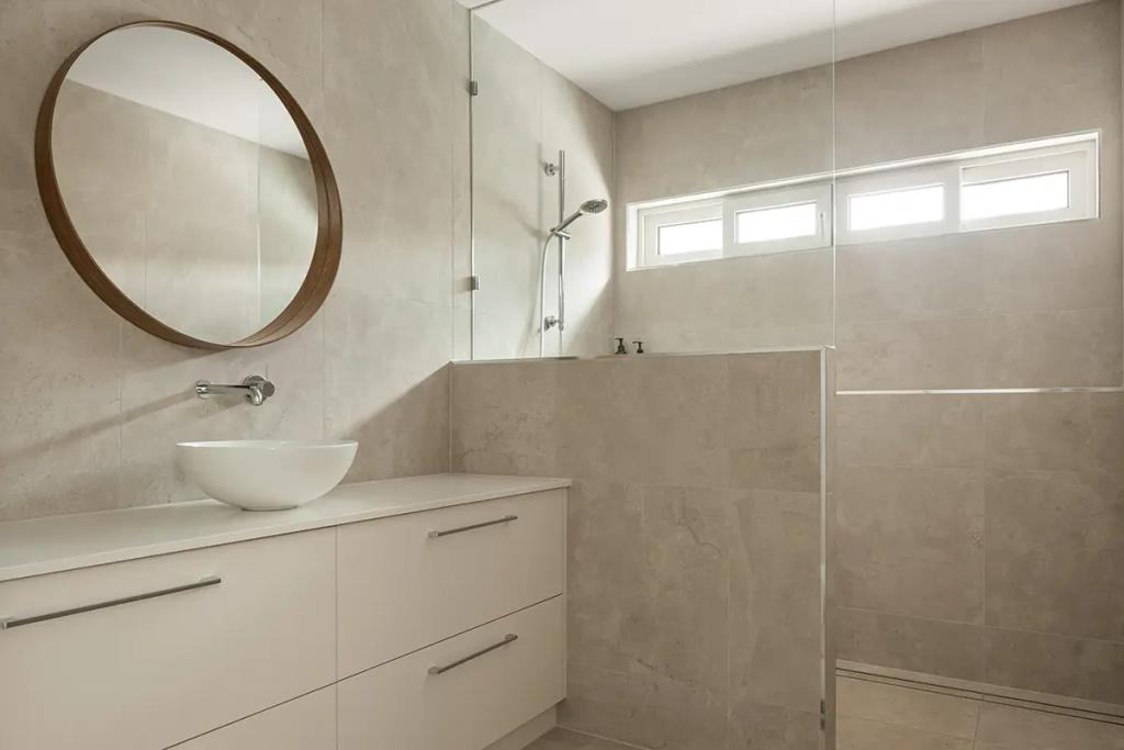 Cheltenham (Tiled bathroom with round mirror and open shower)