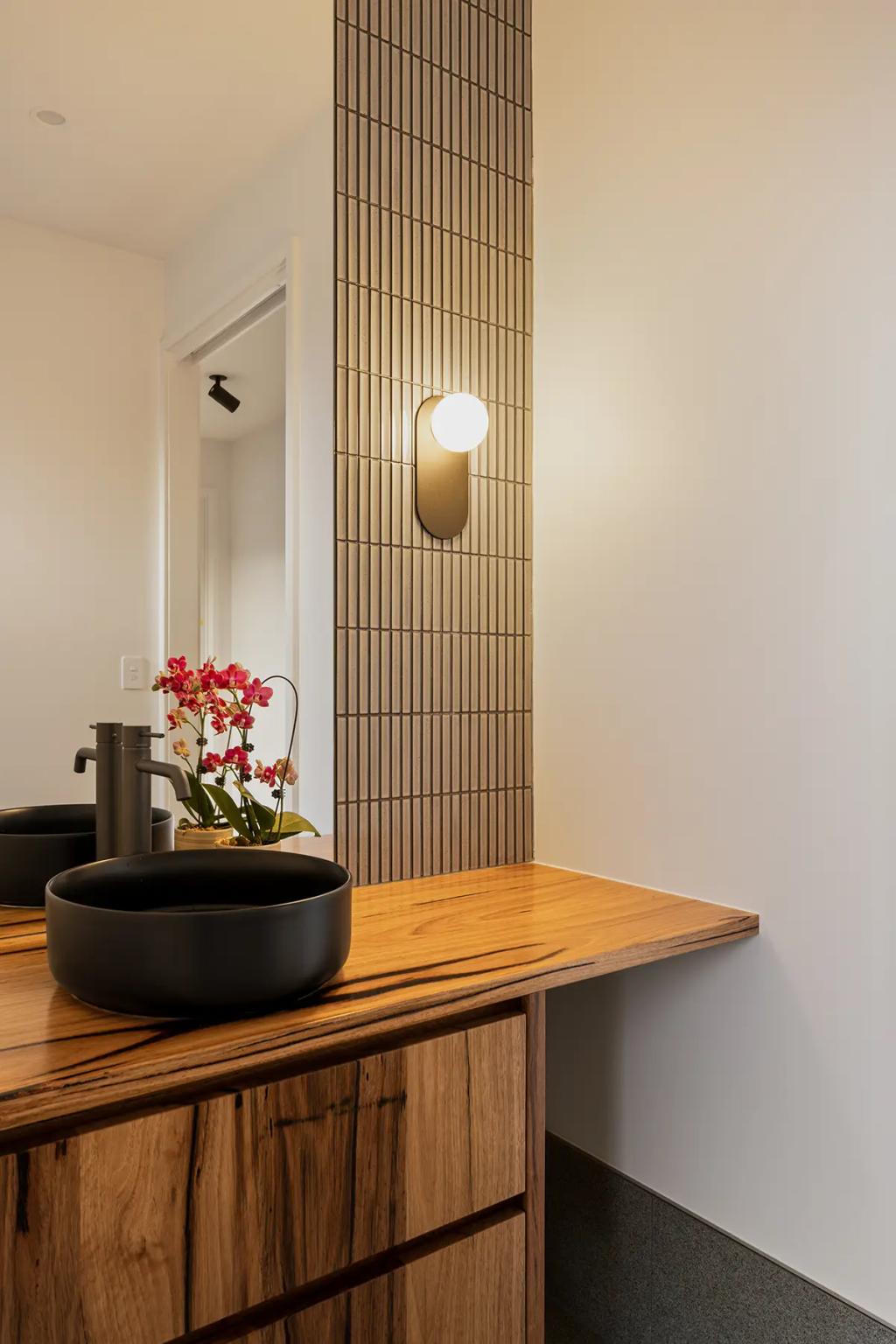 Project Treevue (Modern bathroom Interior with a wooden vanity top and a small potted orchid on the counter)