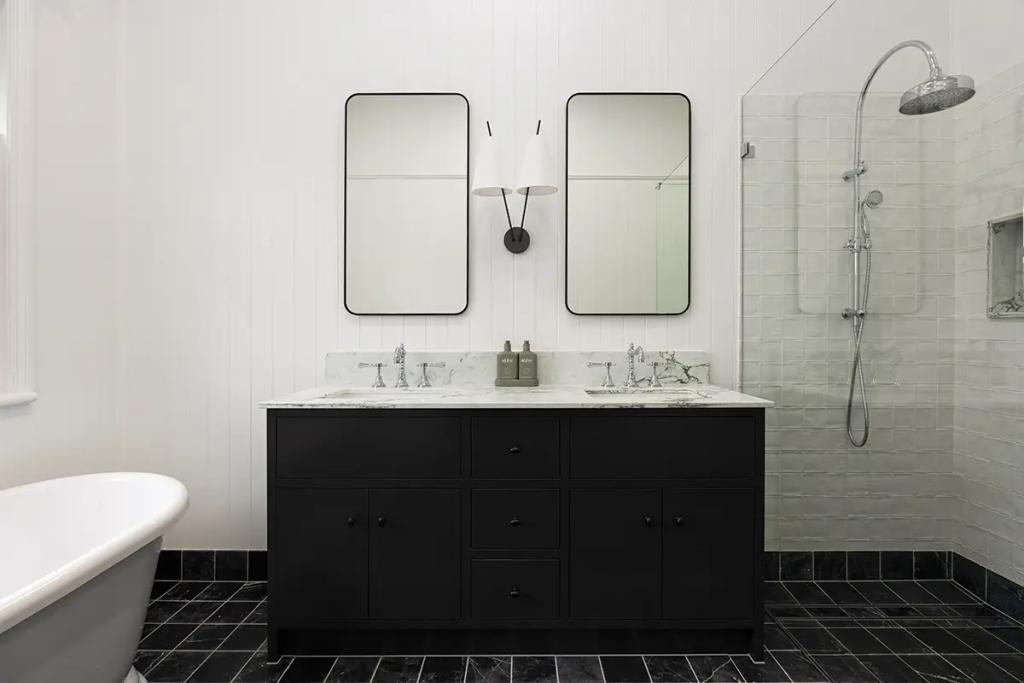 Project Franklin (Black vanity with marble top between mirrors and shower.)