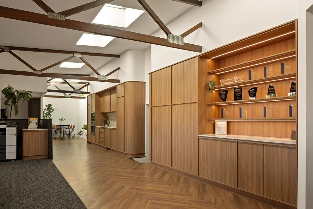 Award display and kitchenette in timber-accented office