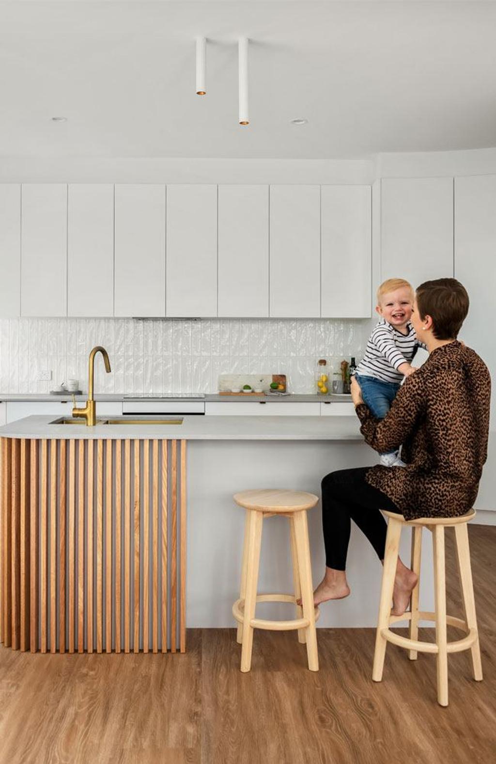 Project Drummond (Girl sitting in a wooden high chair holding a kid on the kitchen table)
