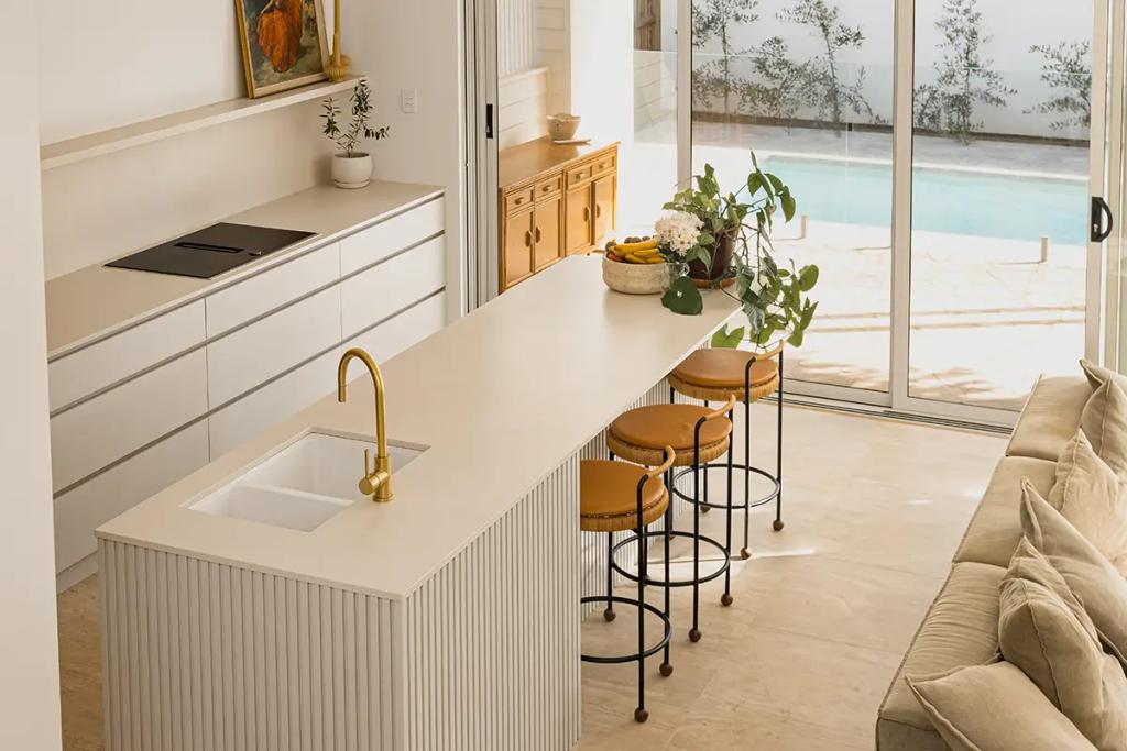 Project Alice (A modern kitchen with overlooking a pool through glass sliding doors)