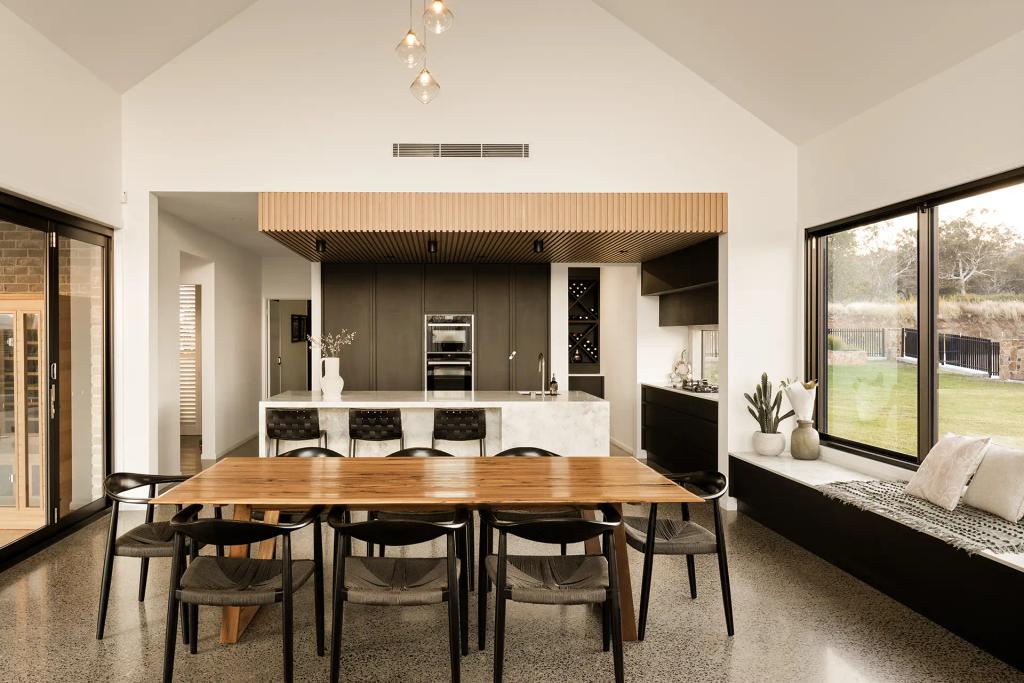 Project Mount Rascal (Open-plan kitchen and dining area with wooden table, modern black chairs, and large windows overlooking yard)