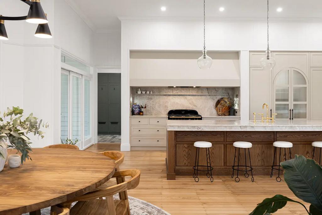 Project Franklin (Kitchen island and oven framed by warm wood and light)