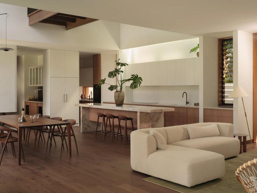 Project Riverton (Open-plan kitchen, dining, and living area with wood floors, light cabinetry, and neutral furniture.)