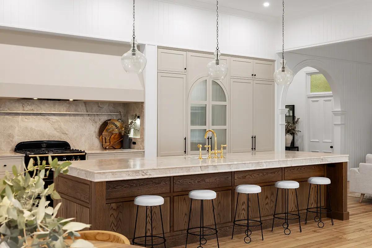 Project Franklin (Dark timber island with stone benchtop, taupe cabinetry and glass pendant lights)