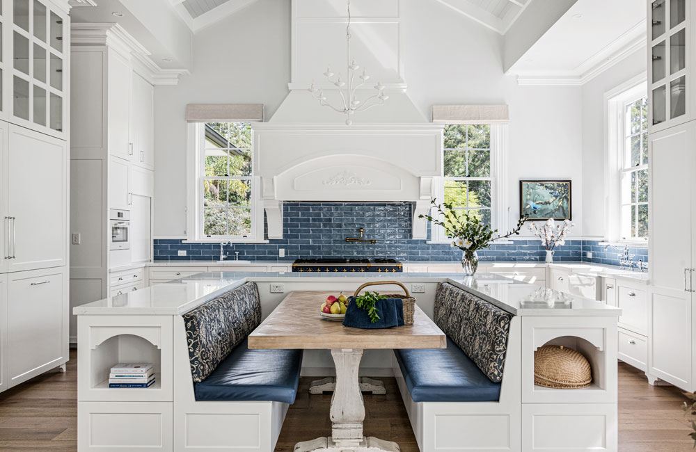 Project Ben (White kitchen island with navy banquette seating, blue subway splashback and vaulted ceiling)