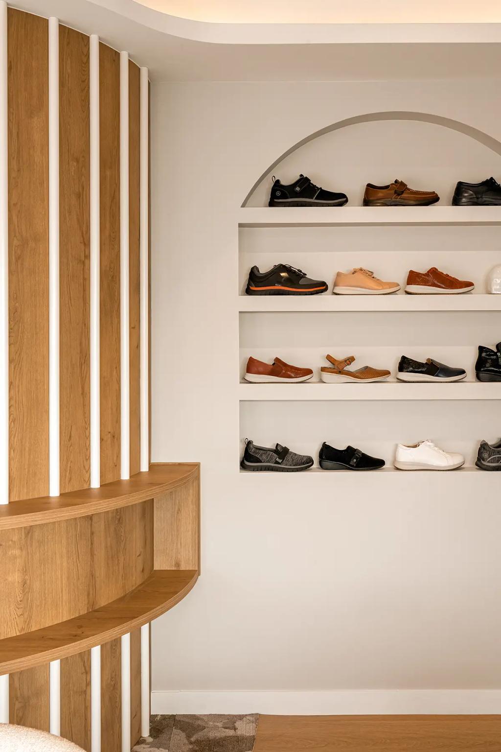 Lavish Constructions - Sole Podiatry (Curved wood shelf beside arched shoe display wall.)