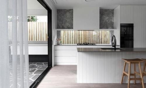 Project Mackenzie (White shiplap island with dark benchtop, window splashback and sliding doors to the patio)