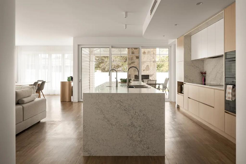 Cheltenham (Stone kitchen island facing patio with glass doors)