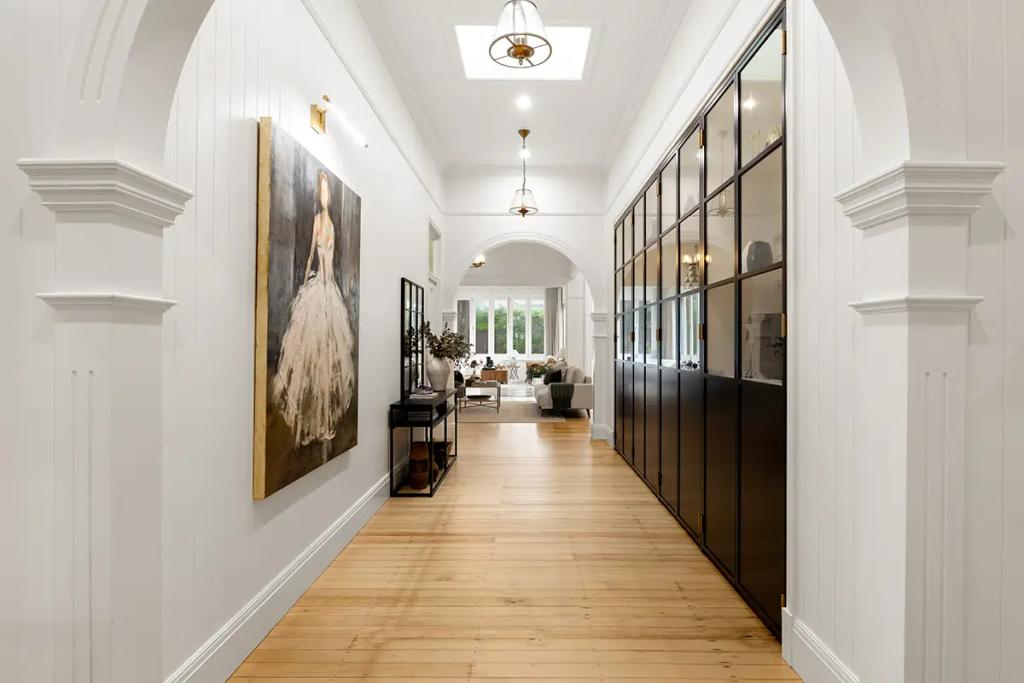 Project Franklin (Refined hallway with arched ceilings and skylight, leading to a sunlit living area.)