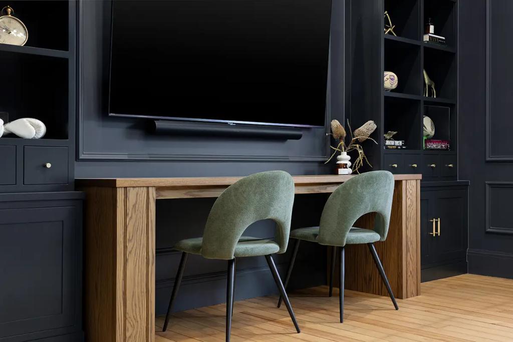 Project Franklin (Dark media wall with TV, shelves, and wood desk setup)