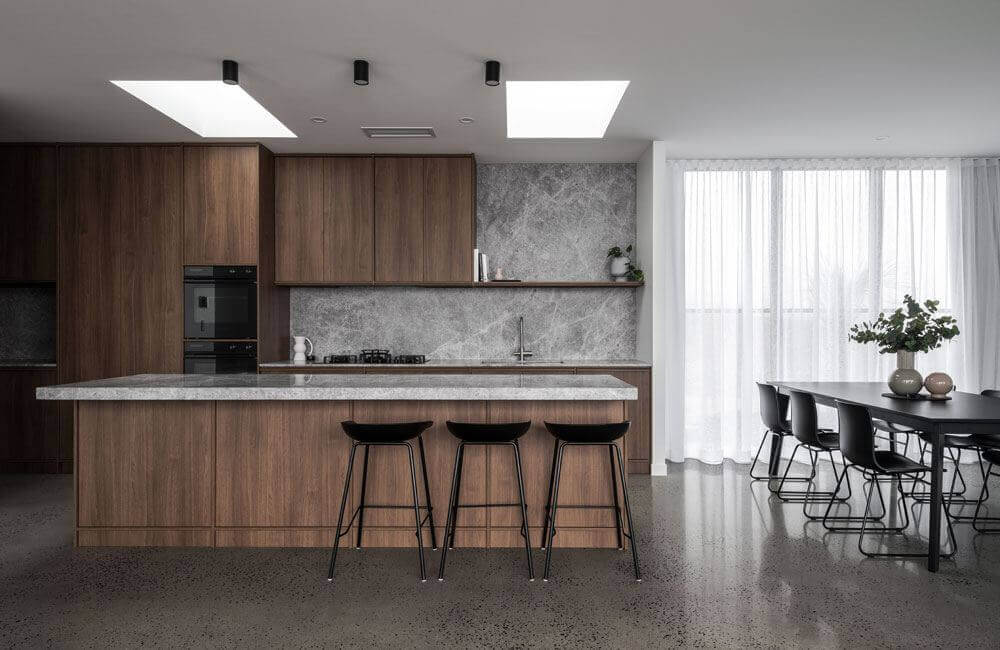 Black Beauty (Timber island with stone benchtop, dark cabinetry, marble splashback and black dining setting)