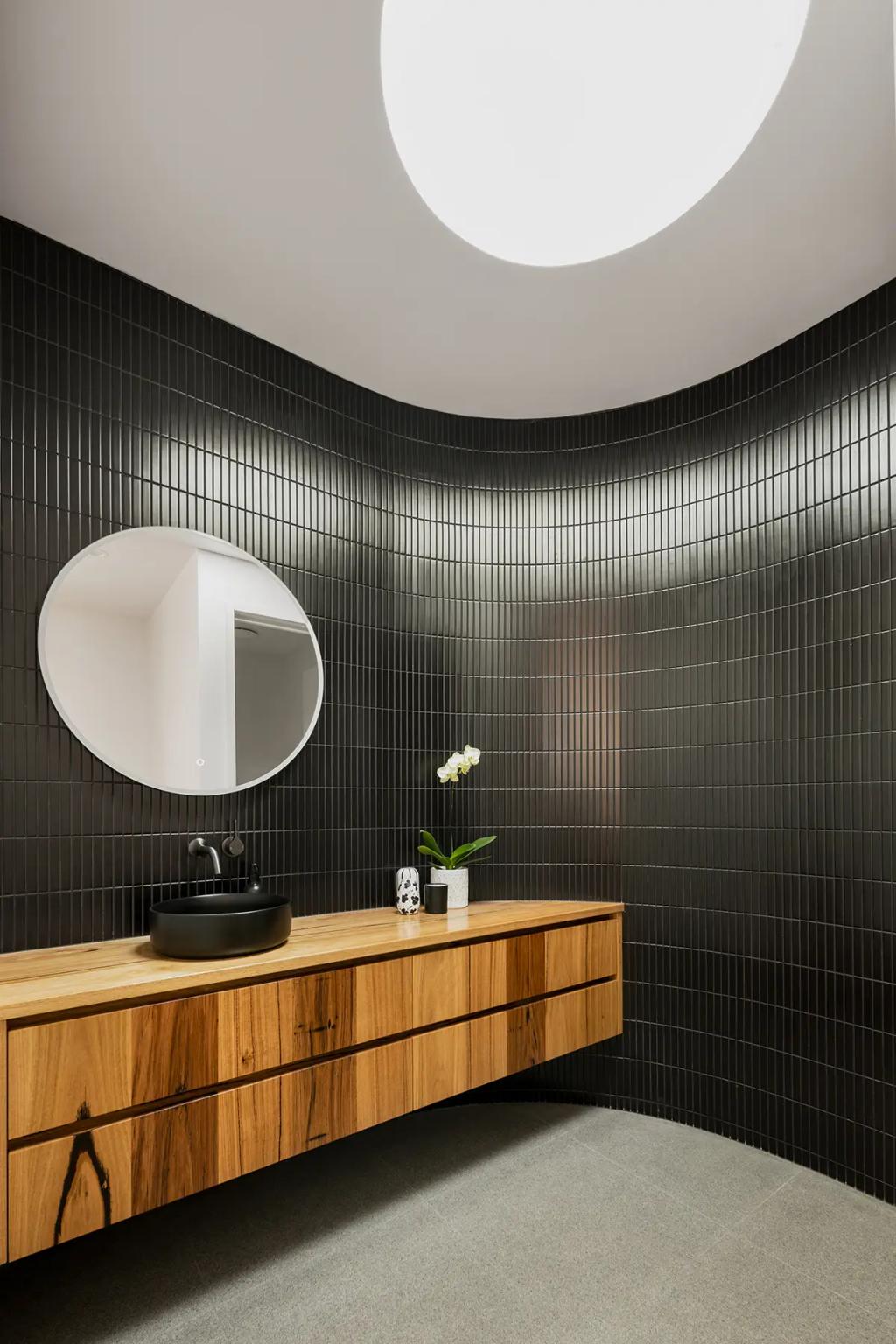 Project Treevue (A modern bathroom with a round mirror and skylight)