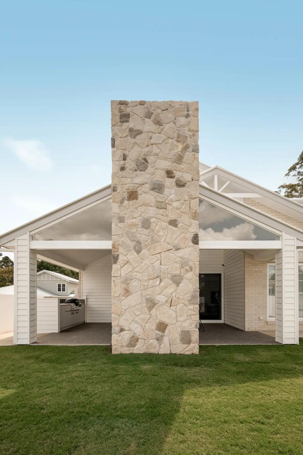 Cheltenham (Stone chimney centered on white gabled patio area)