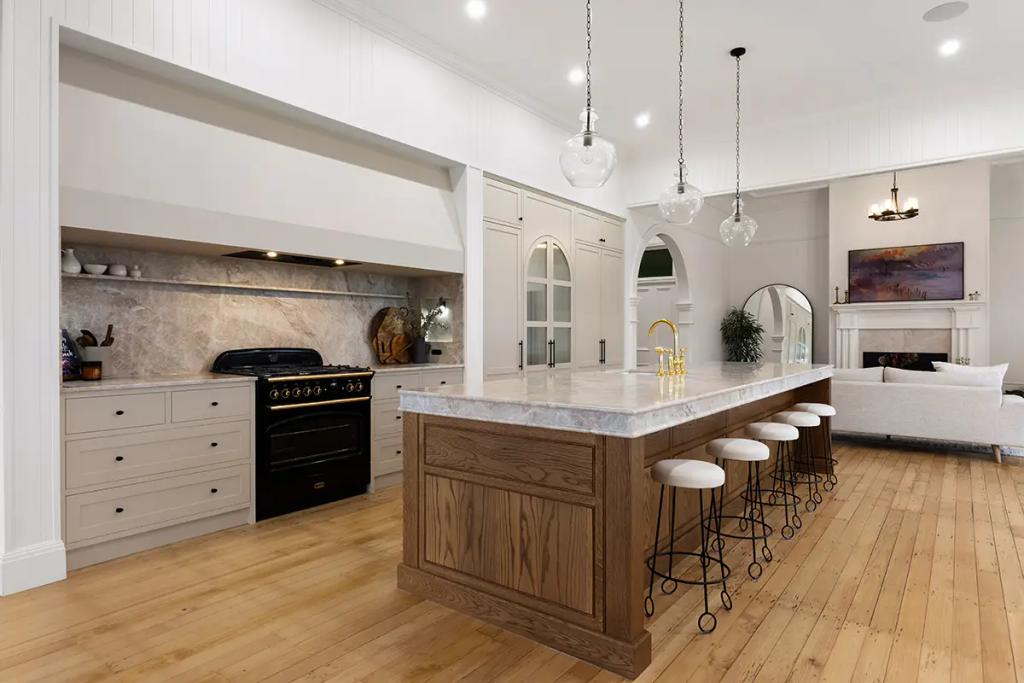 Project Franklin (Open kitchen with pendant lights and black oven.)