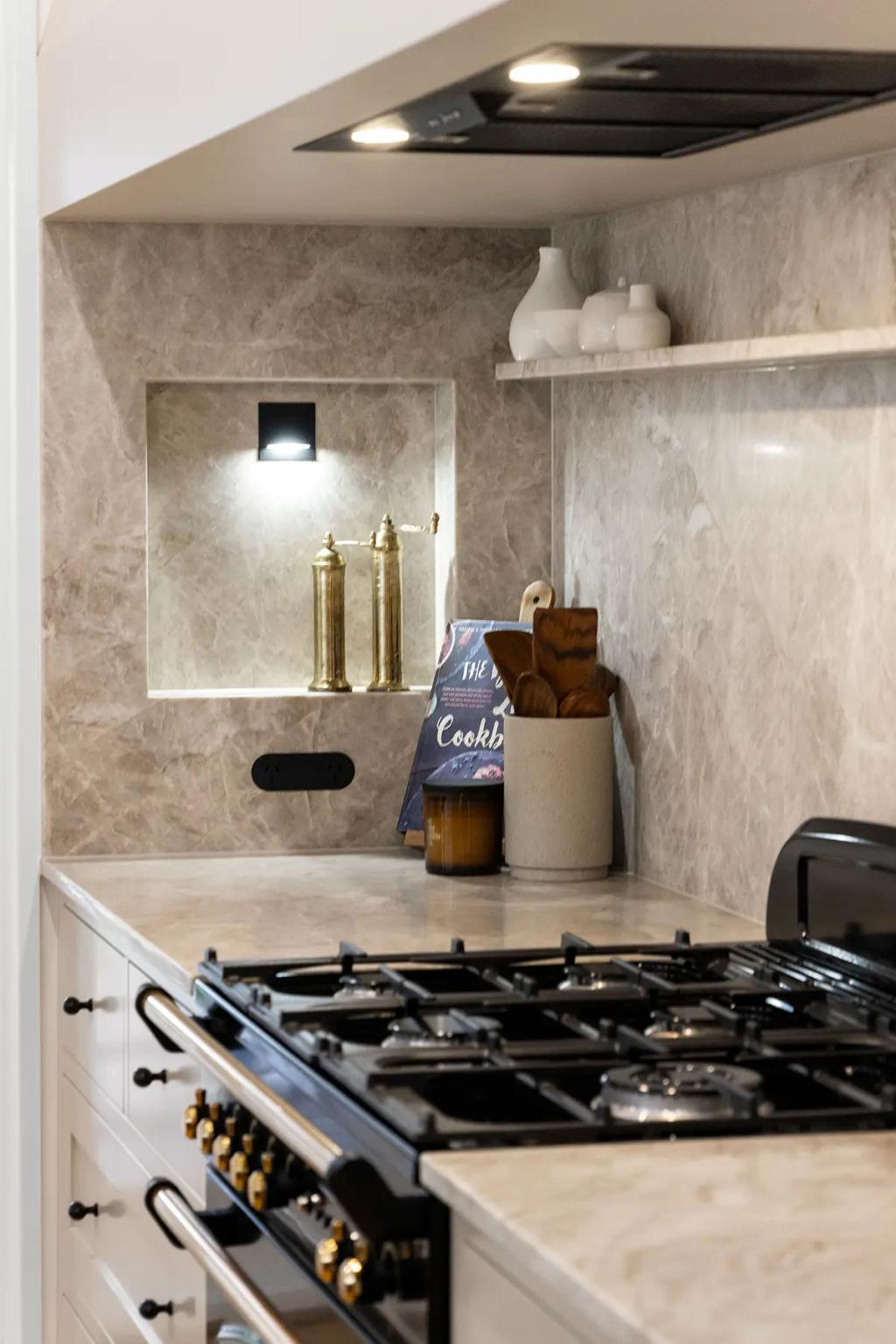Project Franklin (Close-up of marble splashback with niche lighting and decor.)