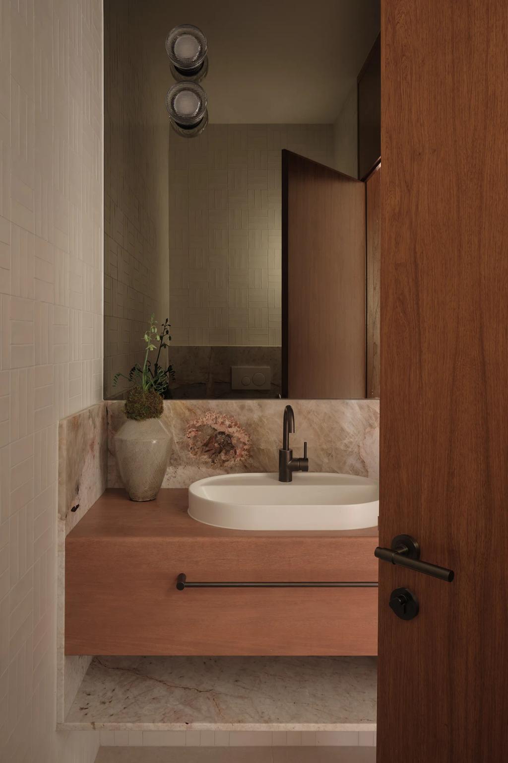 Project Riverton (Powder room with a floating wood vanity, oval undermount sink, marble backsplash, and large mirror.)