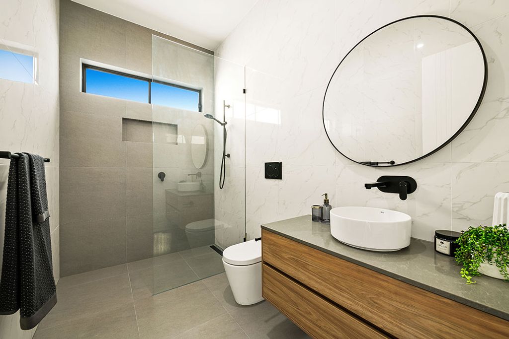 Project San Michelle (bathroom with circular mirror and glass divider)