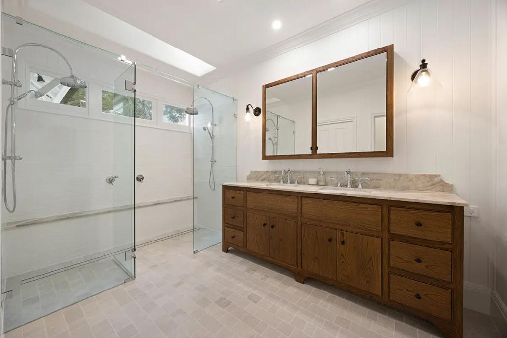 Project Franklin (Double shower and vanity in light, wood-accented style)
