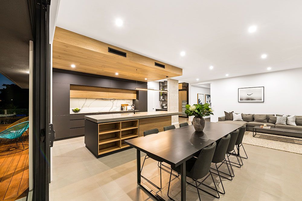 Project San Michelle (Open-plan kitchen with dark cabinetry, timber-lined ceiling and black dining setting)